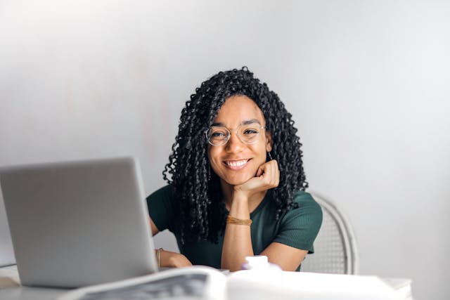 someone sitting in front of an open laptop