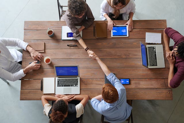 A workspace with collegues and their laptops