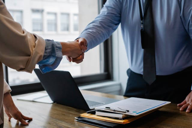 A property manager and landlord shaking hands